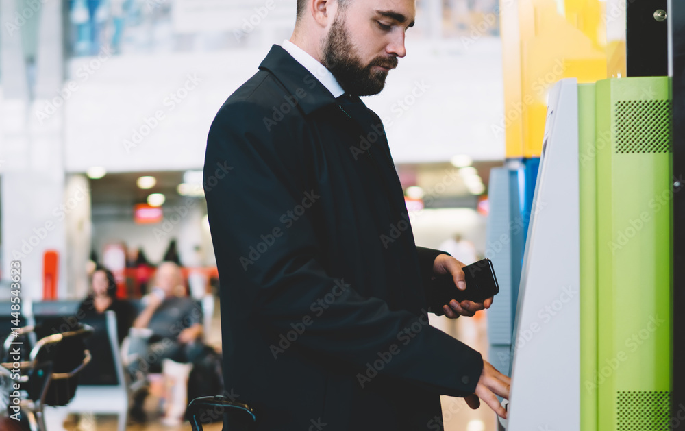 Man standing near terminal in airport