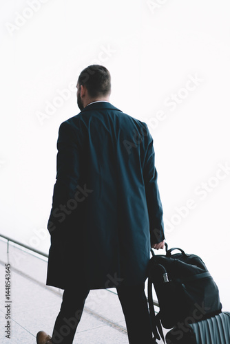 Obraz na płótnie Anonymous with luggage walking in airport hallway w salonie