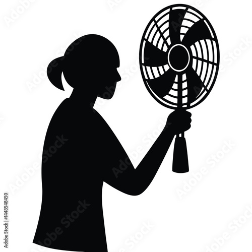 Silhouette Of Woman Cooling Herself With Handheld Fan On A Hot Day.