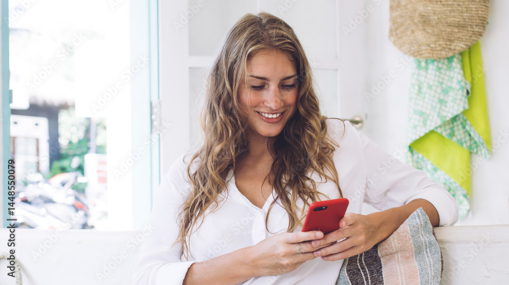 Delighted female having rest and browsing mobile phone