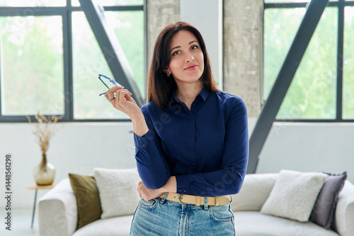 Obraz na płótnie Portrait of young positive business woman looking at camera in office with couch w salonie