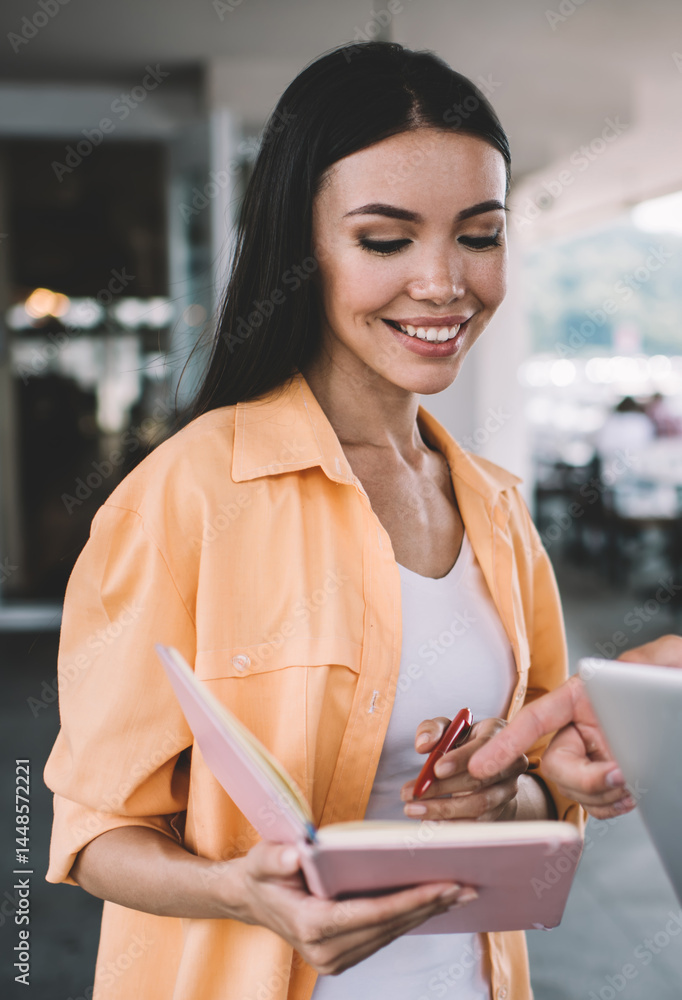 Ethnic woman consulting with male colleague in cafe