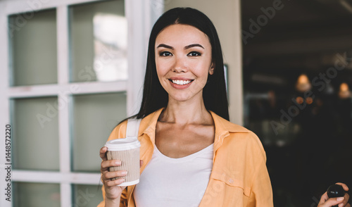 Obraz na płótnie Cheerful ethnic woman standing with cup of coffee w salonie