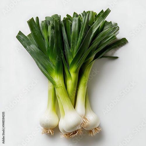 A group of four leeks are displayed against a white backdrop