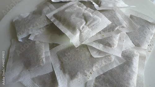 Chamomile tea bags on a turntable. Herbal tea bags. Slow motion