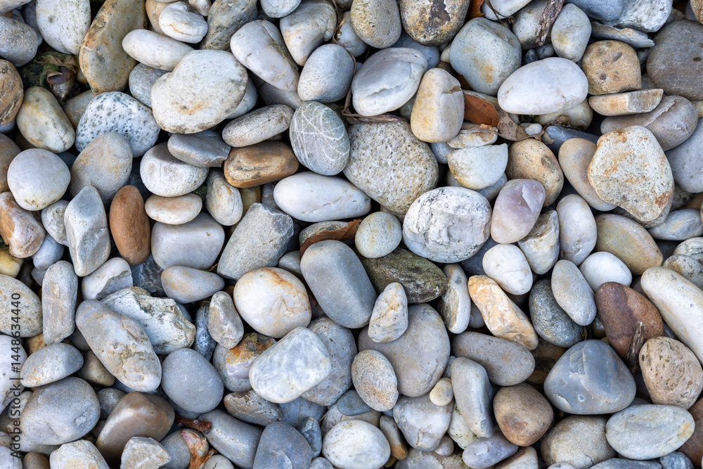 Polished river stones creating a natural textured background Polished river stones creating a natural textured background