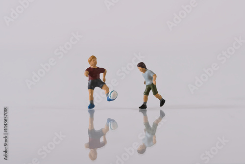Children playing football, miniature figure scene