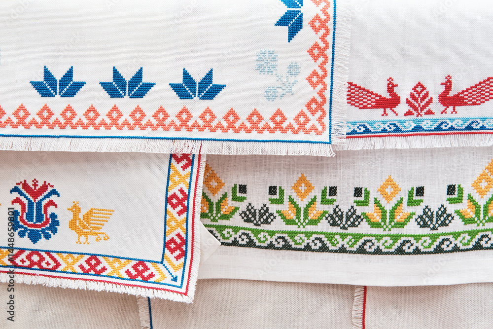 Fototapeta premium Traditional slavic embroidery patterns on white linen fabric