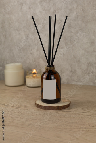 Aroma diffuser with reeds on beige background in beautiful composition