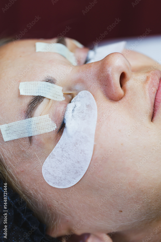 Eyelash gluing method. Close-up of a woman's face during the procedure of Botox lamination of eyelashes. Eyelash care: lifting and curling, lamination and eyelash extensions.