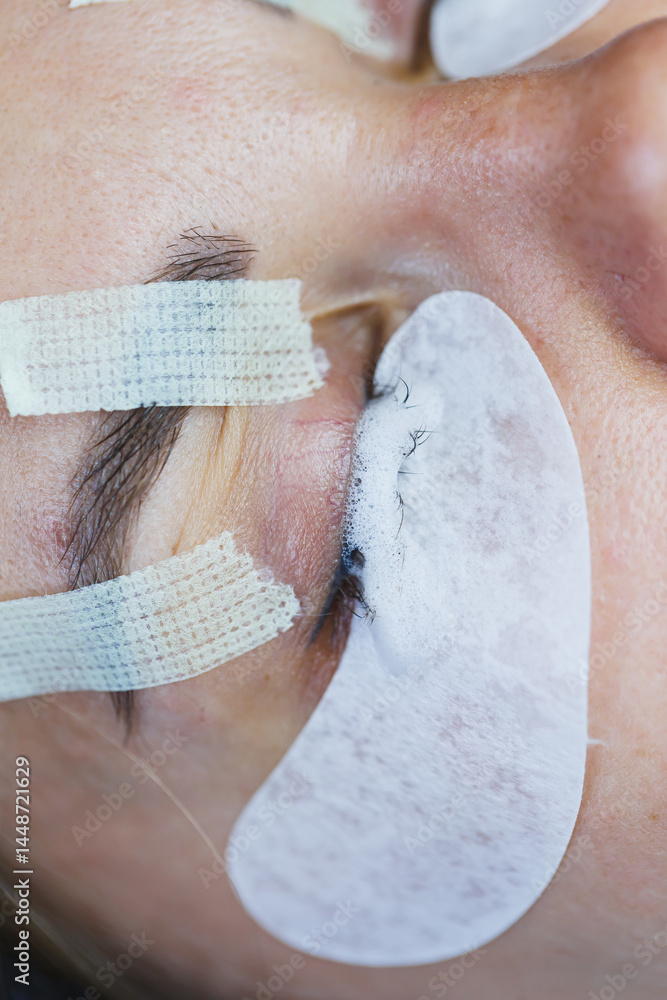 Eyelash gluing method. Close-up of a woman's face during the procedure of Botox lamination of eyelashes. Eyelash care: lifting and curling, lamination and eyelash extensions.