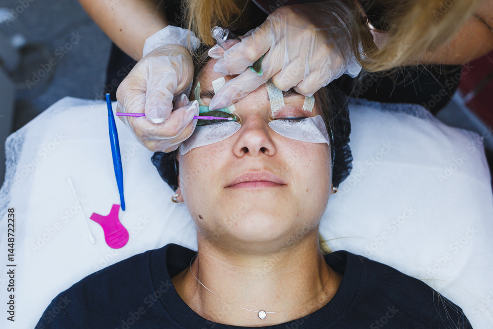 Eyelash gluing method. Close-up of a woman's face during the procedure of Botox lamination of eyelashes. Eyelash care: lifting and curling, lamination and eyelash extensions.