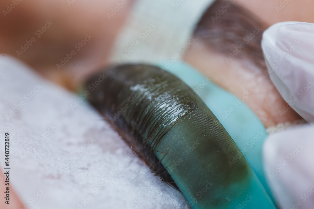 Eyelash lamination close-up on a woman's face. Women's beauty procedures.