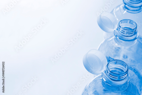 Fotografija Plastic bottles with so-called tethered caps in monochrome blue