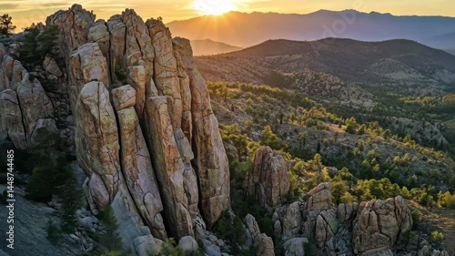 Drone captures breathtaking rock climbing experience at sunset in rugged mountain terrain, Rock climber high up on rocky mountain of canyon cinematic drone shot