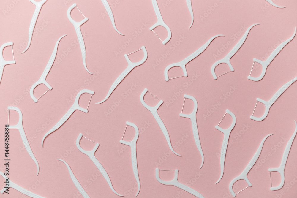 Dental floss with handle on pink background, flat lay