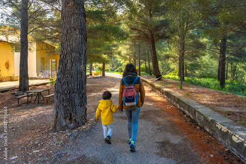 Obraz na płótnie Mother and son walking in the sanctuary of fontcalda, gandesa, tarragona w salonie
