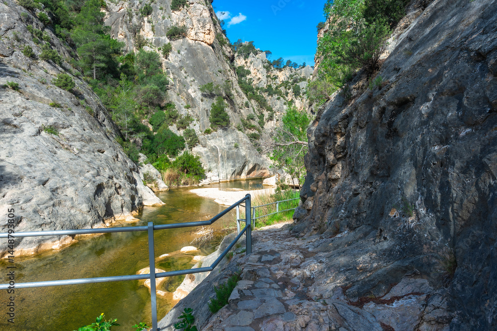 Hiking trail following canal de fontcalda in catalonia, spain