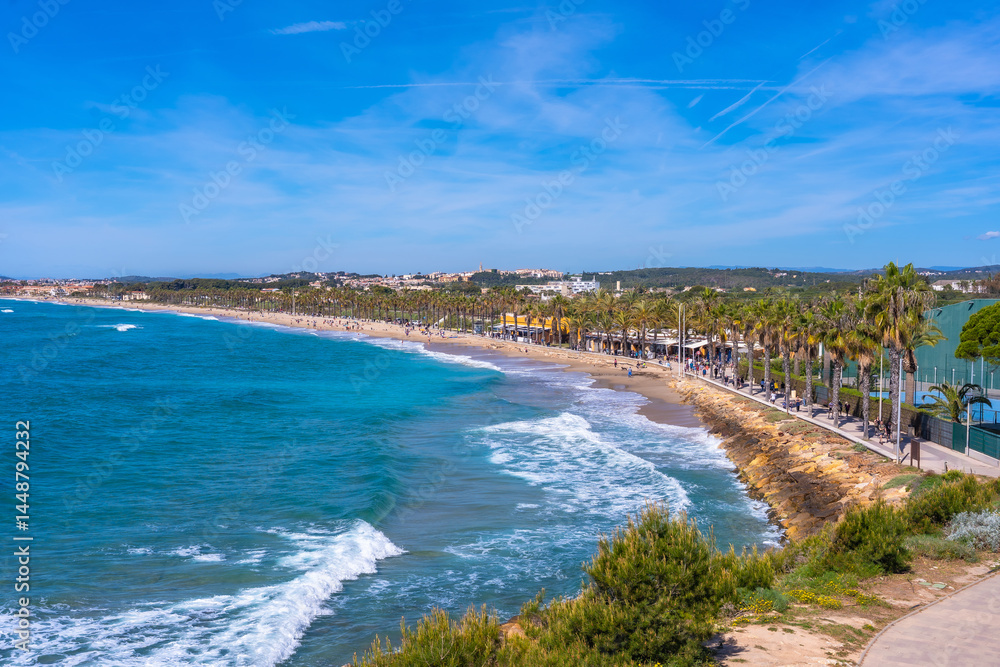 Tourists walking on cami de ronda in roc de sant gaieta, comarruga, tarragona, spain