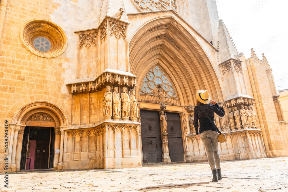 Tourist admiring tarragona cathedral facade in catalonia, spain