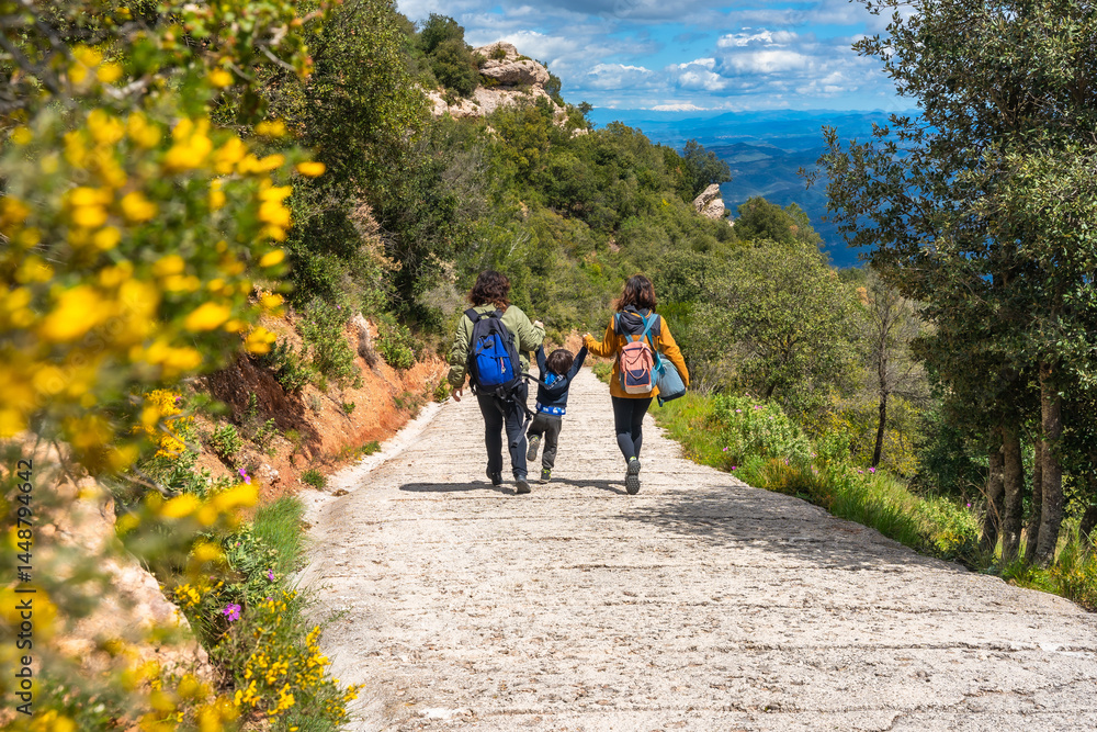 Family hiking in montserrat mountains enjoying scenic view