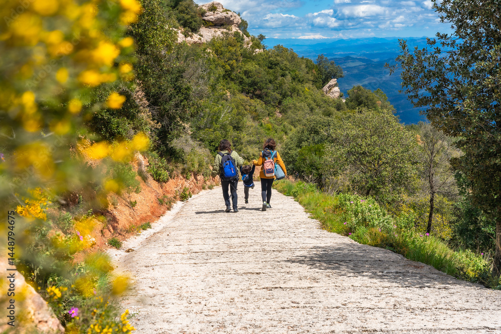 Family hiking in montserrat mountains enjoying scenic view