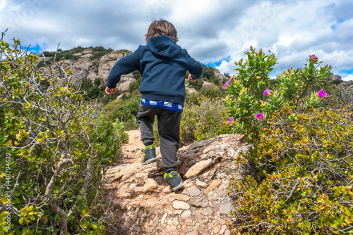 Obraz na płótnie Child hiking on montserrat mountain path exploring nature w salonie