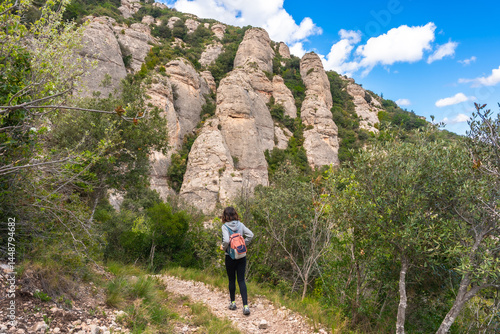 Obraz na płótnie Tourist walking on a path in montserrat mountains near barcelona, catalonia, spain w salonie