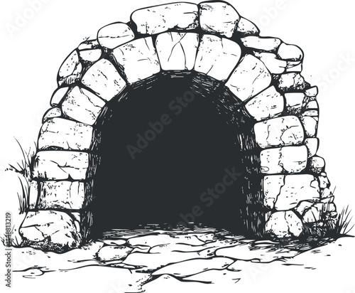 Stone arch cave entrance with dark opening surrounded by rocks and grassy ground outdoors