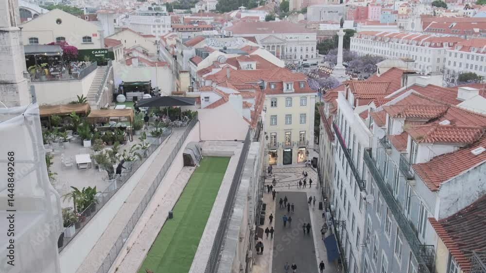Tourists and locals walking down rua augusta in lisbon, portugal, with the rua augusta arch visible in the distance and the city skyline beyond Tourists and locals walking down rua augusta in lisbon, portugal, with the rua augusta arch visible in the distance and the city skyline beyond
