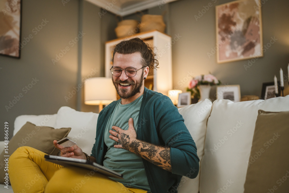 Fototapeta premium online shopping man hold credit or debit card make purchase at home