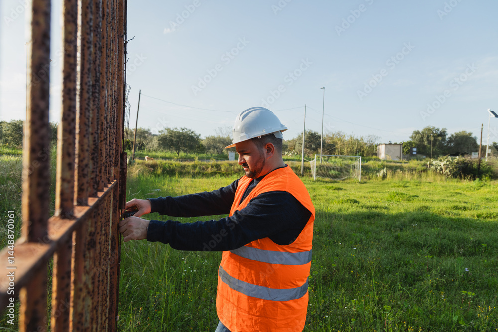Worker Measuring The Iron Door
