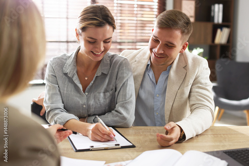 Couple having meeting with banker at desk in office