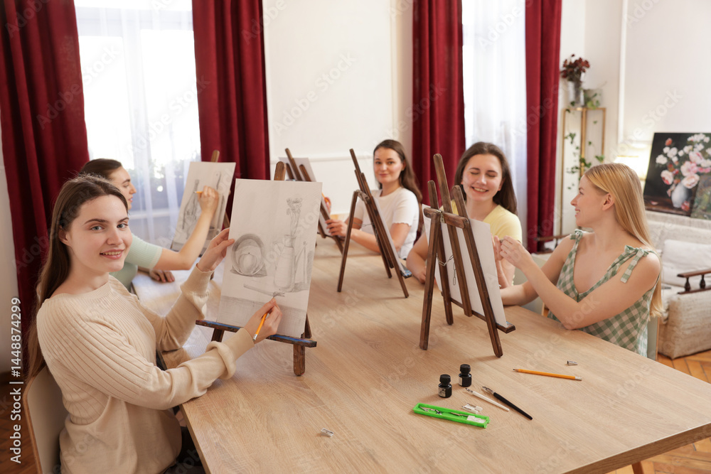 Fototapeta premium Group of women learning to draw at wooden table in class
