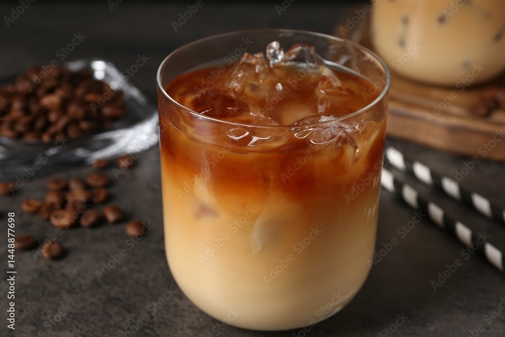 Tasty iced coffee and beans on grey table, closeup Tasty iced coffee and beans on grey table, closeup