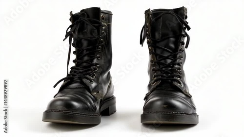 Pair of black leather lace-up combat boots standing on a white background, old and worn, ready for adventure.