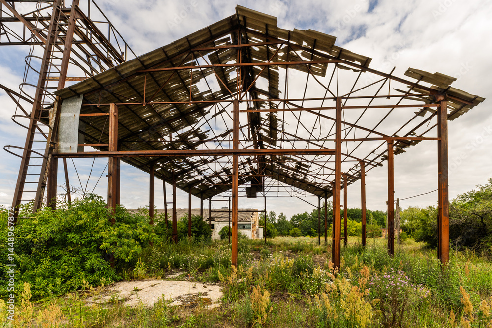 A dilapidated building with a roof that is missing several sections A dilapidated building with a roof that is missing several sections