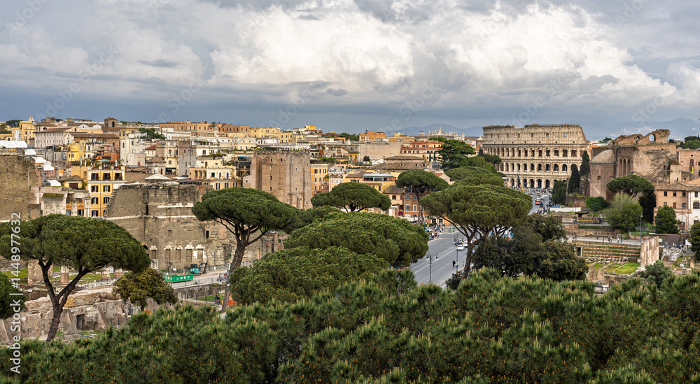 Fototapeta premium Historic landscape featuring ancient ruins and the Colosseum in Rome with overcast skies during midday