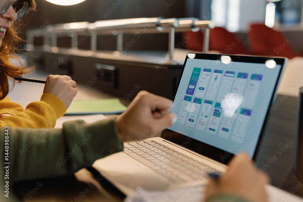 Open laptop monitor of cropped IT company colleagues developing design Open laptop monitor of cropped IT company colleagues developing design