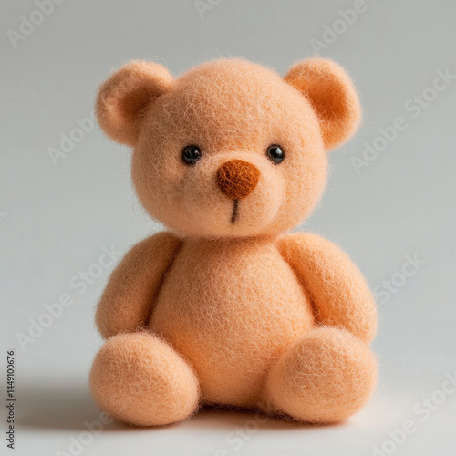 Soft, peach-colored felt teddy bear