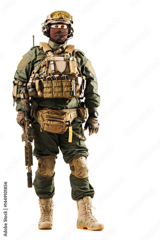 Heavily armed soldier in tactical gear holding a rifle and standing against a white background Heavily armed soldier in tactical gear holding a rifle and standing against a white background