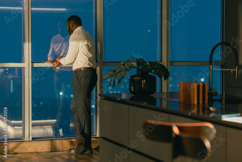 Wallpaper Mural  Man Standing by Window in Modern Home at Night Torontodigital.ca