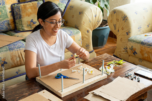 Woman using scissors to cut the petals alyx of lilies for drying