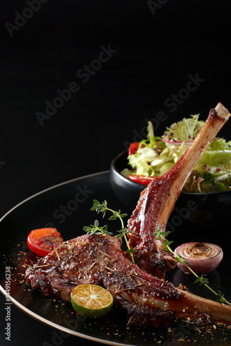 Closeup of grilled lamb chops on a plate
