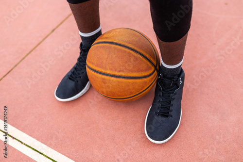 black teenager playing basketball