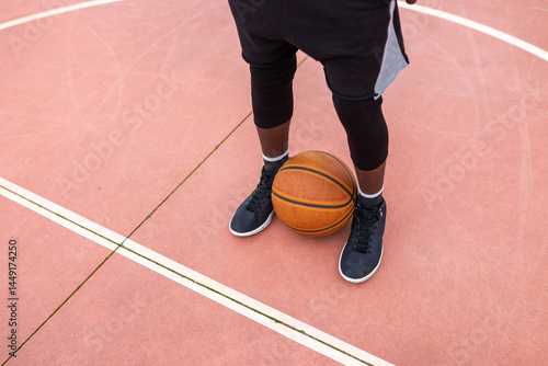black teenager playing basketball