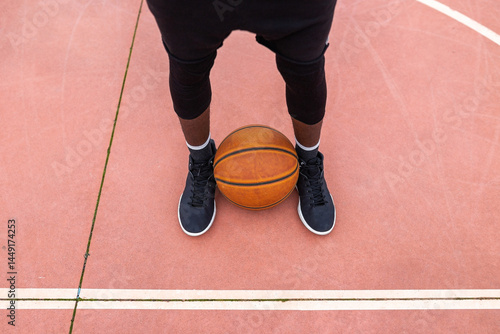 black teenager playing basketball