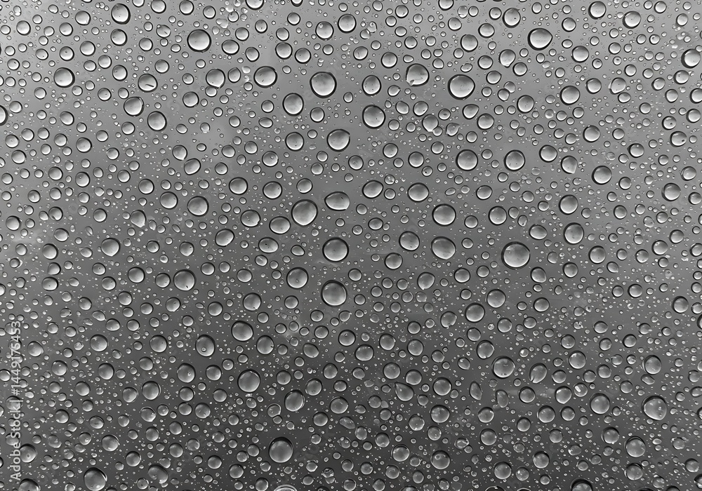 A close up shot of water droplets on a surface creating a textured and reflective abstract pattern A close up shot of water droplets on a surface creating a textured and reflective abstract pattern
