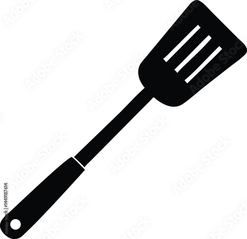 A black spatula featuring three distinct slots is isolated against a clean white backdrop