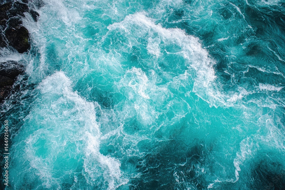 Aerial view captures powerful teal river current swirling around dark rocks dynamically Aerial view captures powerful teal river current swirling around dark rocks dynamically
